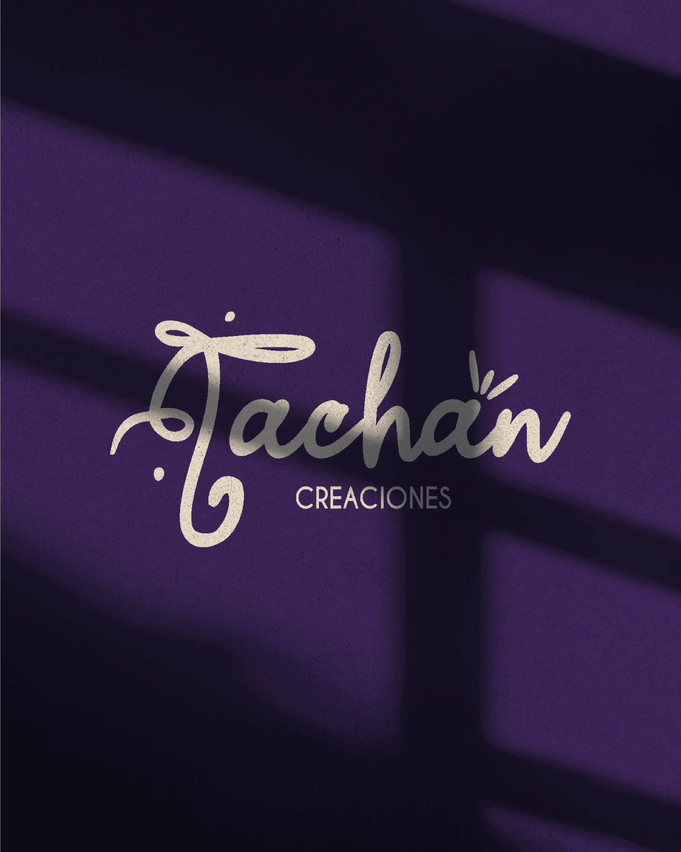 Handwritten Tachán Creaciones logo on textured paper